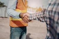Construction worker handshake representing employment opportunities at Oak and Anchor Builders
